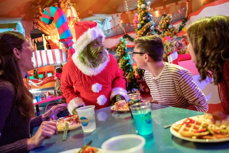 Grinch comendo com visitantes no Natal da Universal Orlando