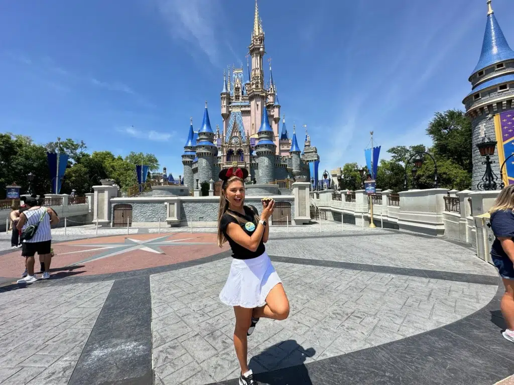 Fernanda Batista (Orlando Diferente) em frente ao Castelo da Cinderela, no Magic Kingdom, com bottom